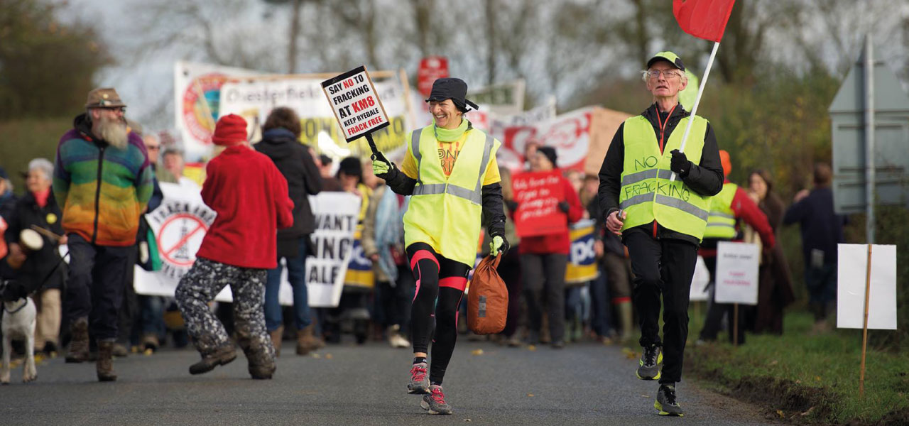 Fracking protestors marching with banners