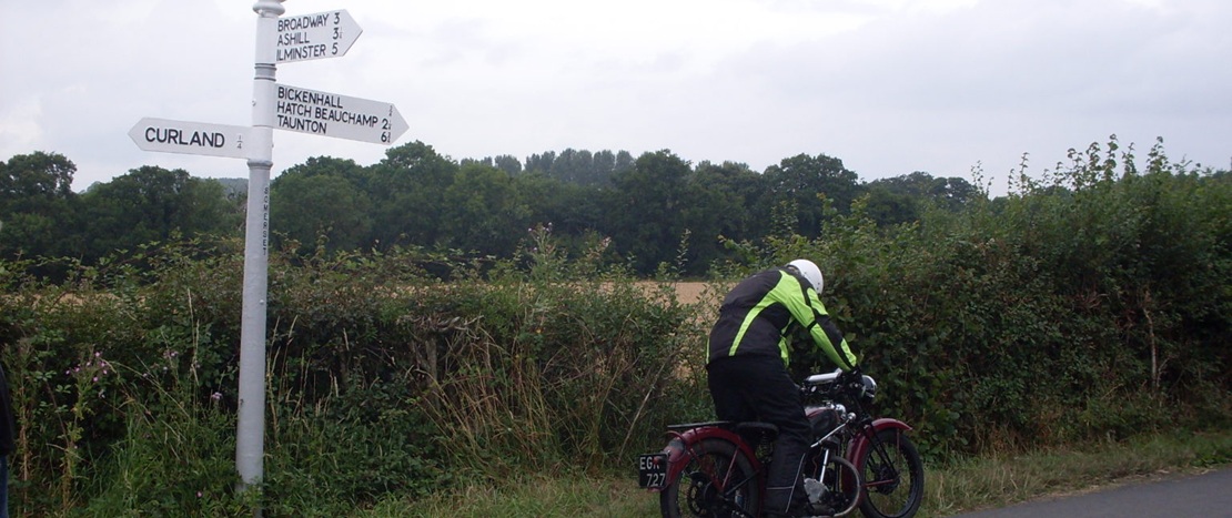 motorcyclist with fingerpost